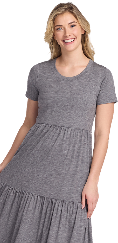 Smiling person wearing a gray short-sleeve dress.