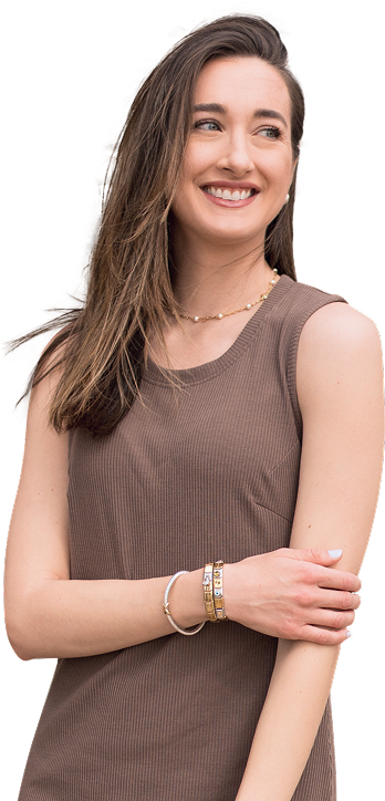 Smiling woman in a brown sleeveless top with bracelets, looking to the side.
