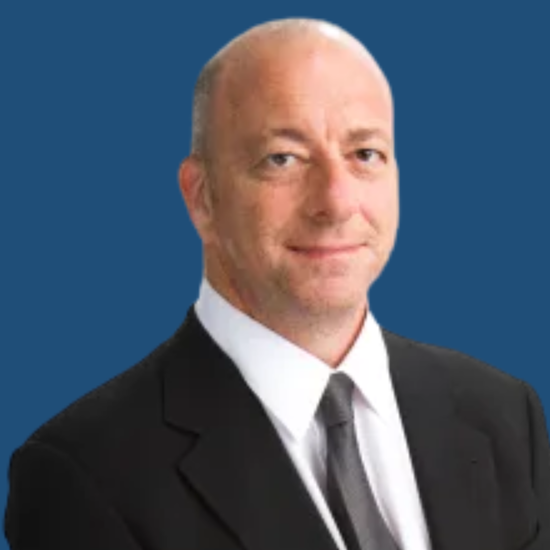Man in a suit with a blue background.