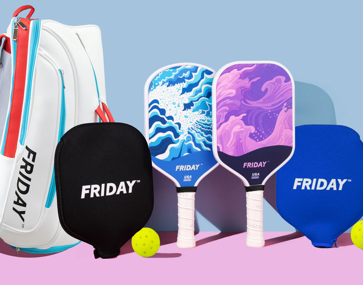 Pickleball paddles with colorful designs, a white bag, and a yellow ball on a pastel background.