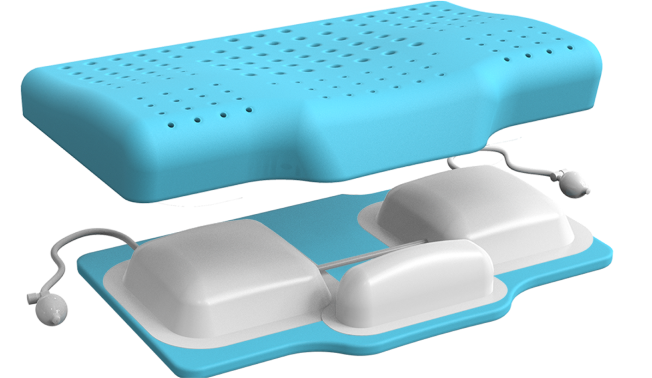 Blue and white ergonomic pillow with ventilation holes and attached cords.