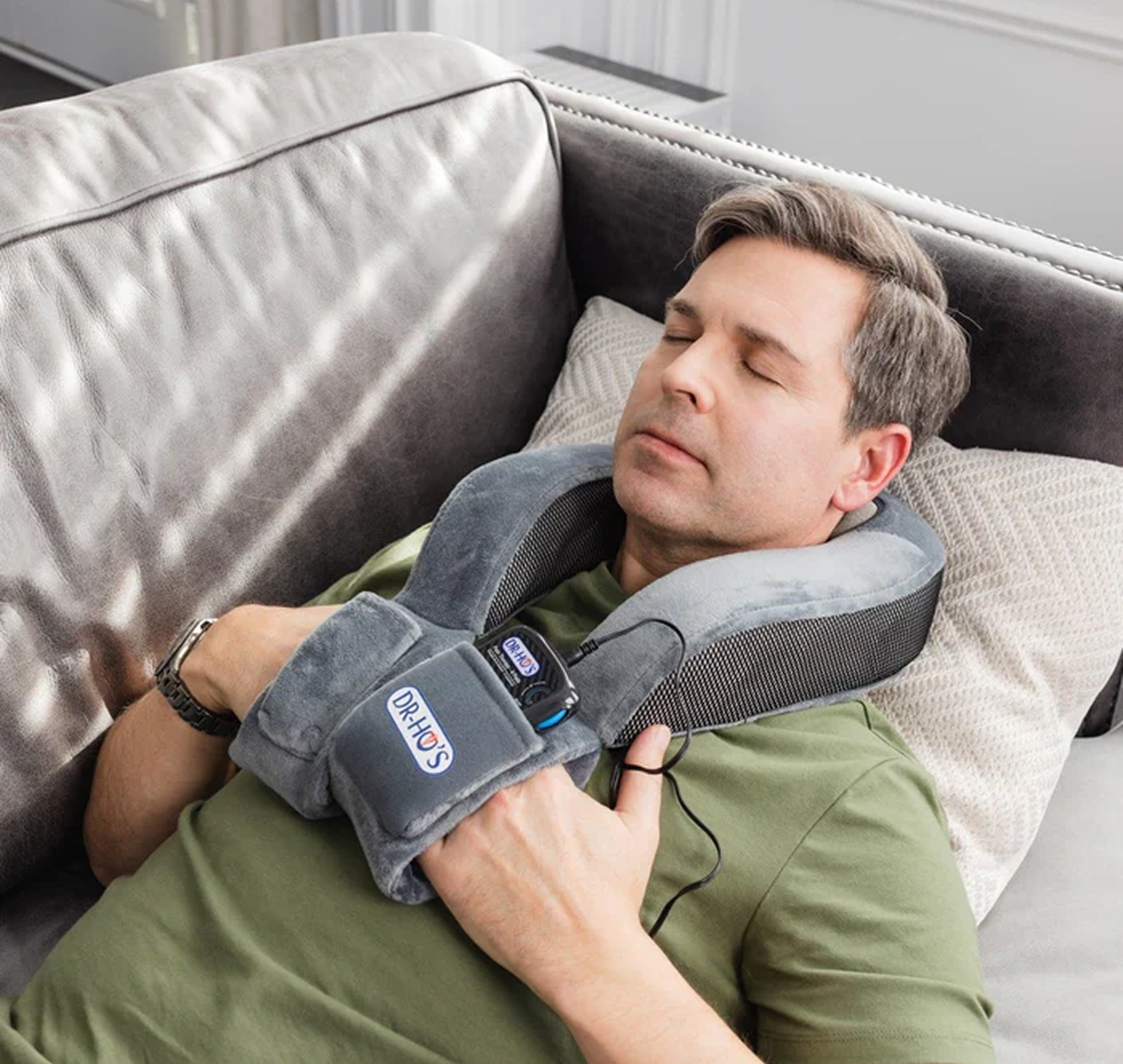 Man relaxing on a couch with a neck massager.