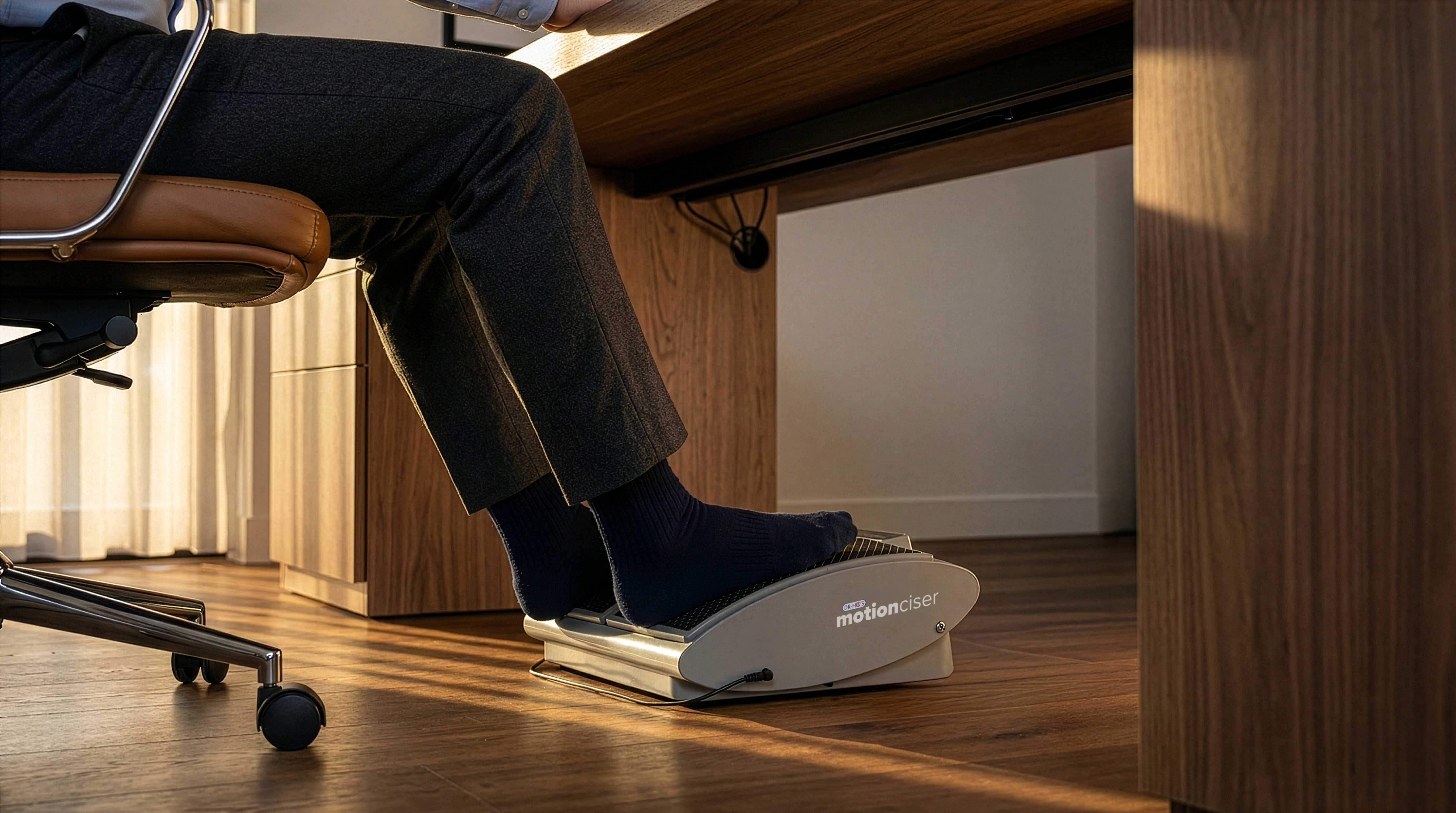 Person using a desk elliptical machine under a wooden desk.
