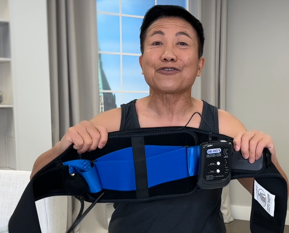 Person holding a black belt with blue and black sections.