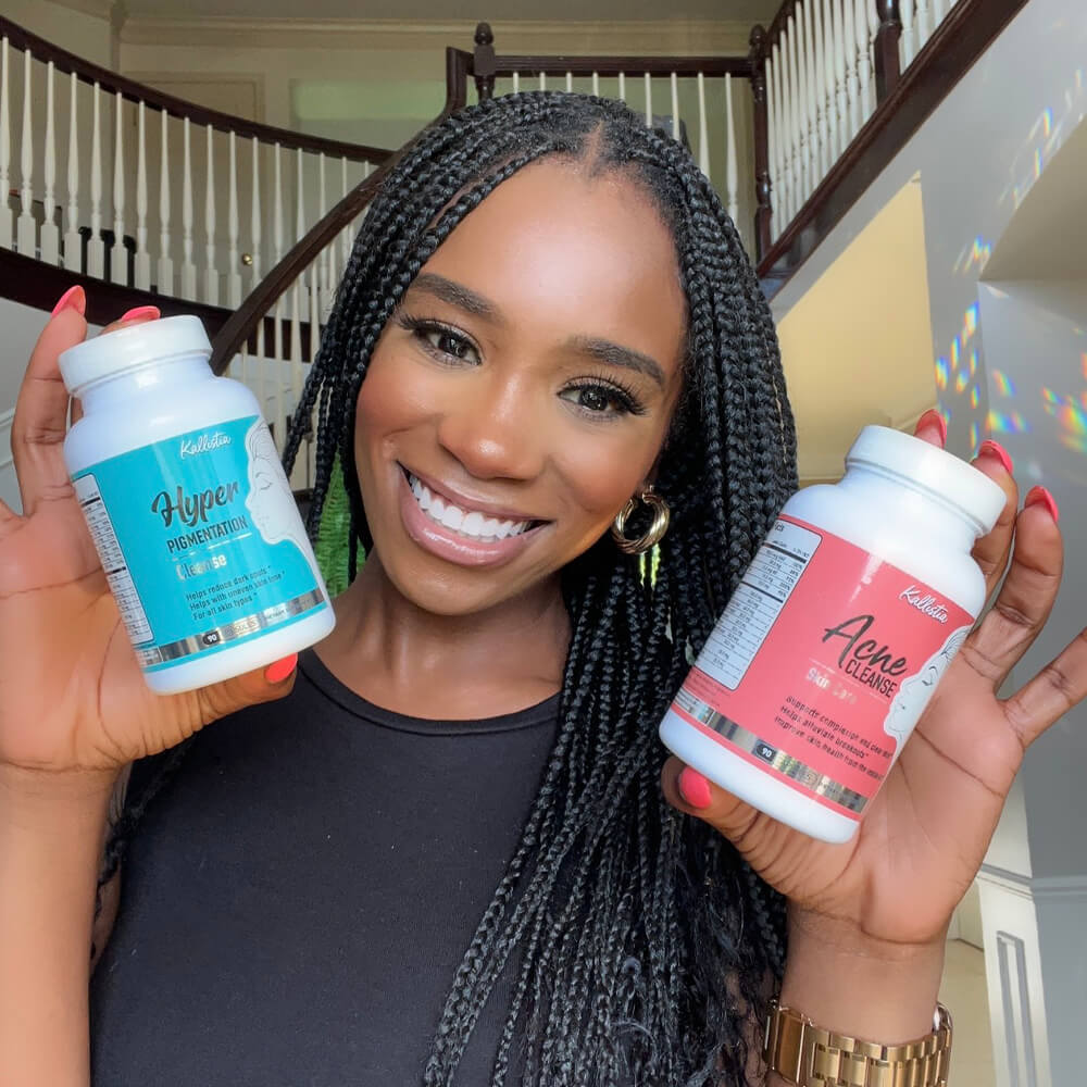 Person smiling, holding two bottles labeled 'Hyper Pigmentation' and 'Acne Cleanse.'