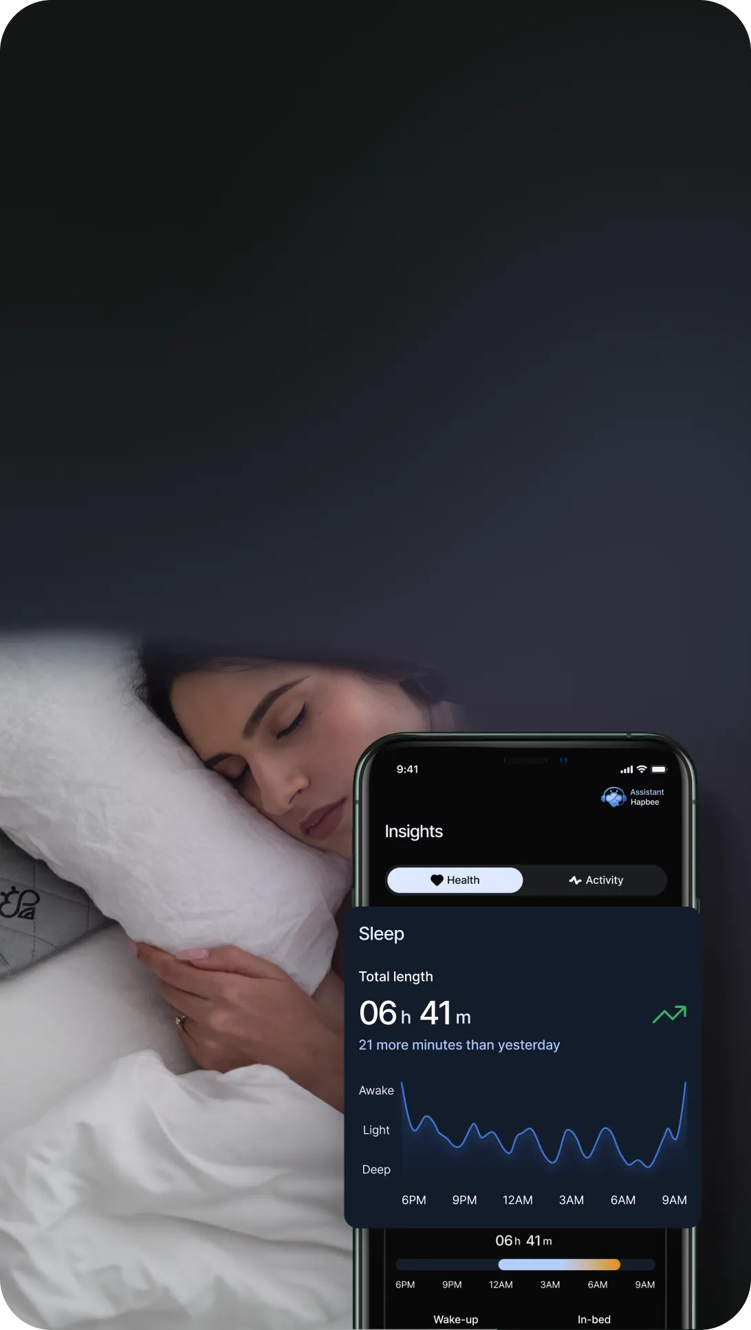 Person sleeping with a sleep tracking app on a smartphone screen.