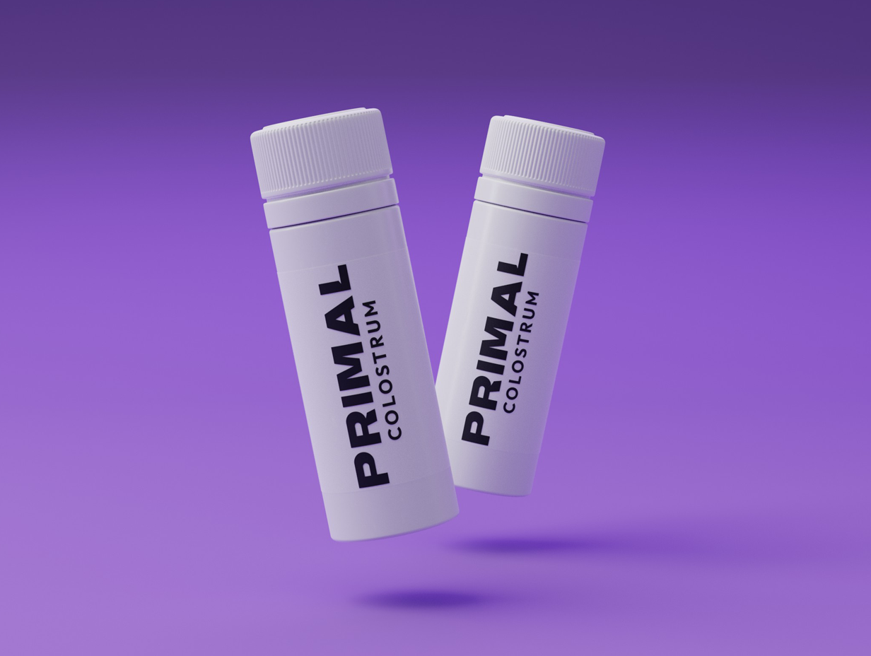Two white bottles marked 'PRIMAL COLOSTRUM' on a purple background.