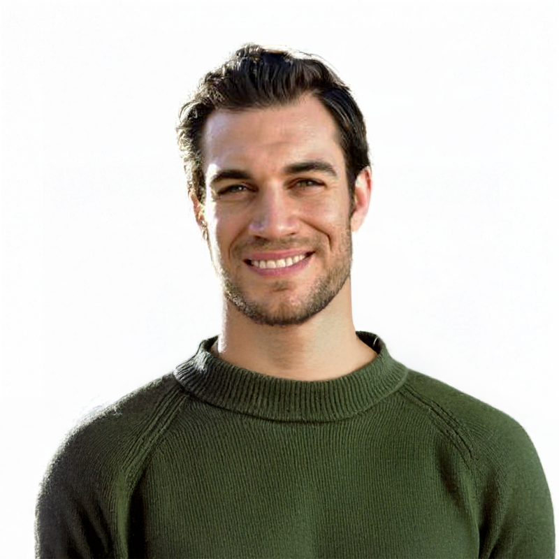 Smiling man in a green sweater against a white background.