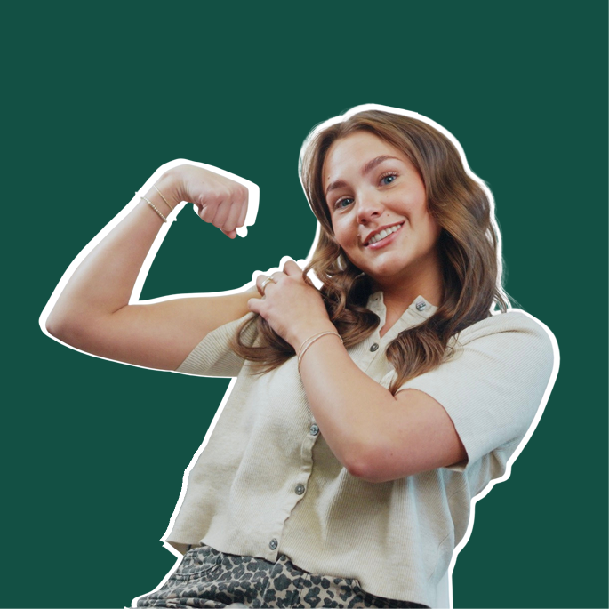 Person smiling and flexing arm muscles against a green background.