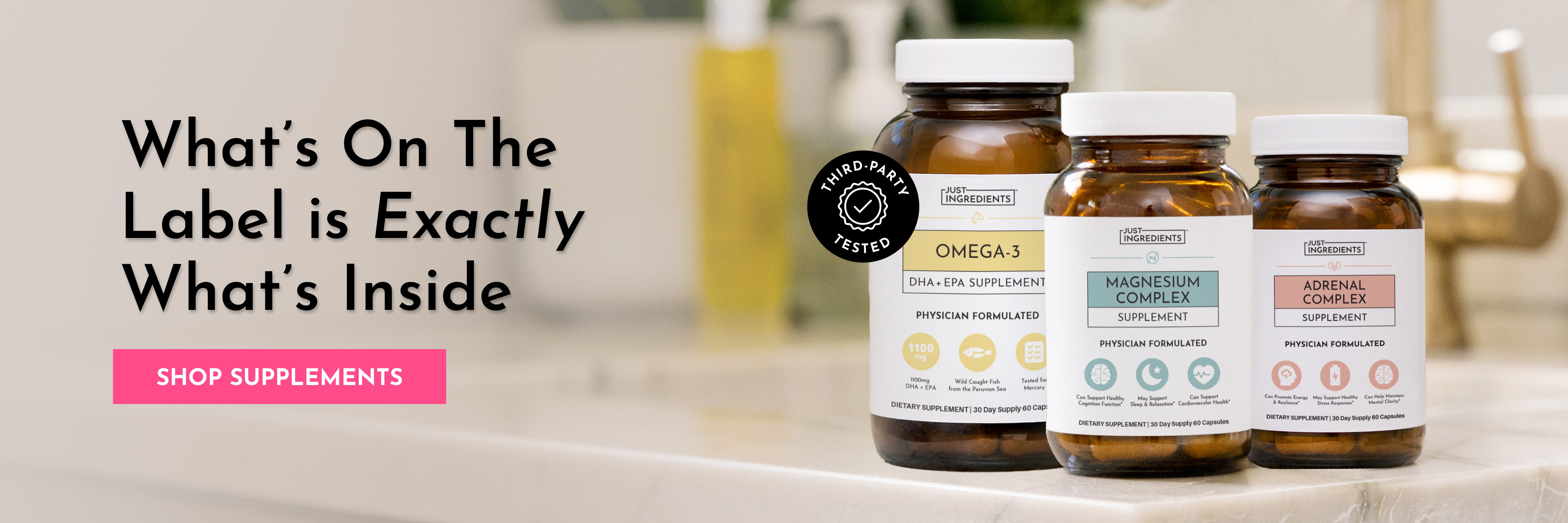 Three bottles of Just Ingredients supplements sit on a counter next to promotional text and a button.