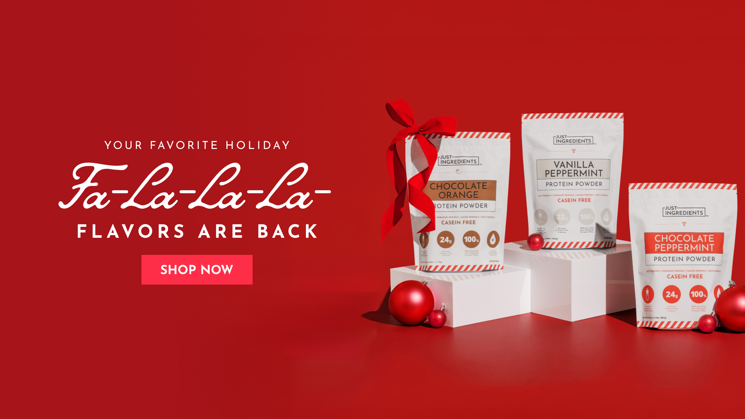 Red background with holiday-themed protein powder packages and festive decorations.