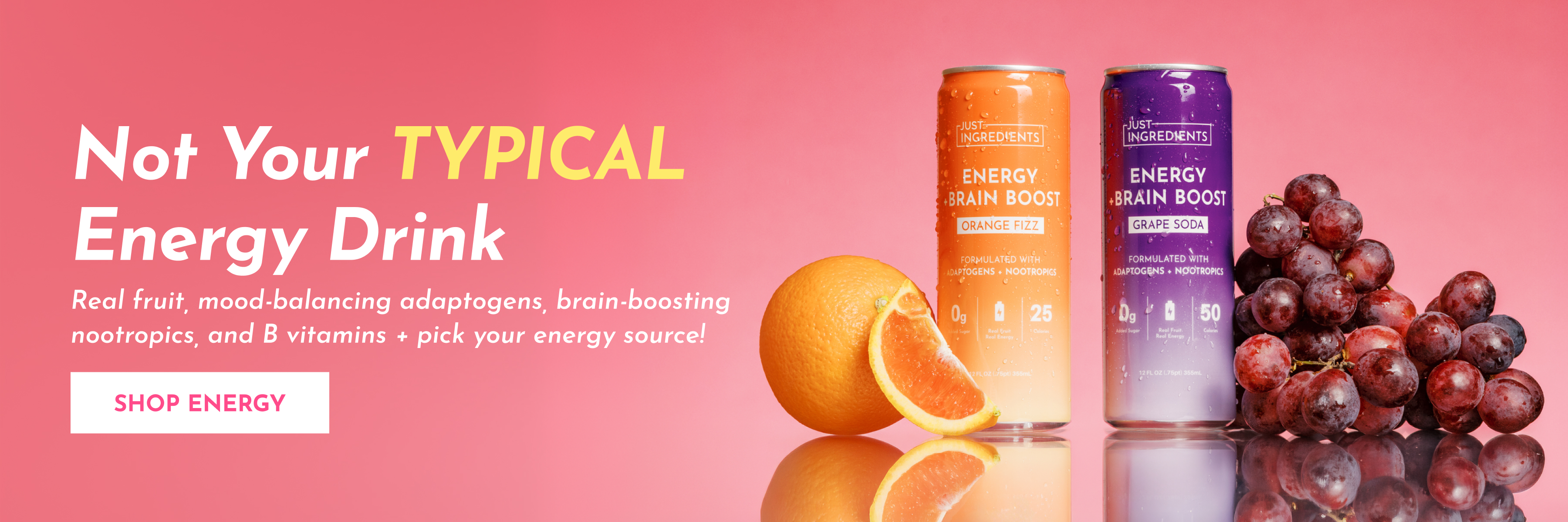 Two cans of Just Ingredients energy drinks, Orange Fizz and Grape Soda, next to an orange and grapes.