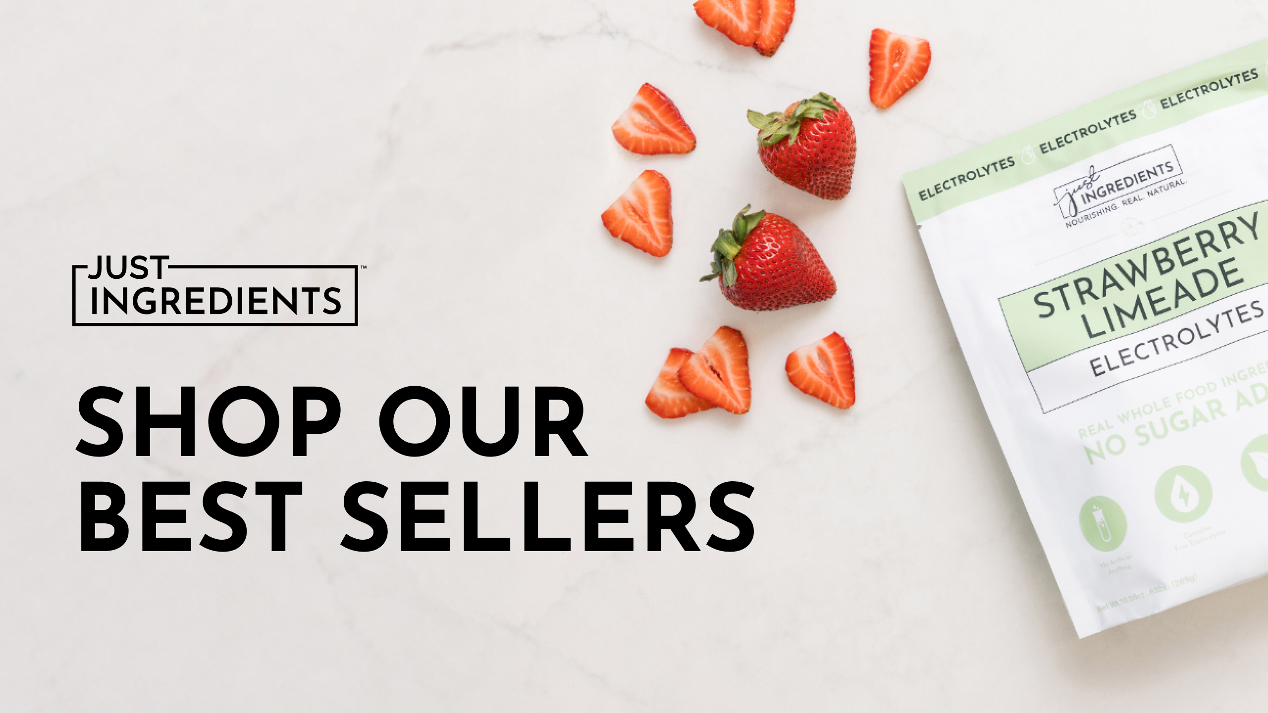 Strawberries and strawberry limeade electrolyte packet on a marble surface.