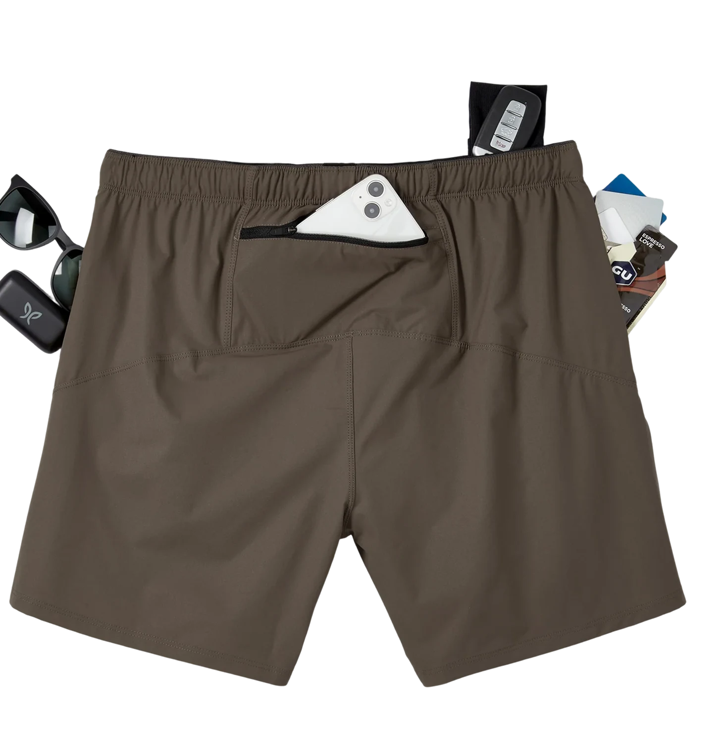 A rear view of brown shorts with various items like a phone, keys, and cards in the pockets.