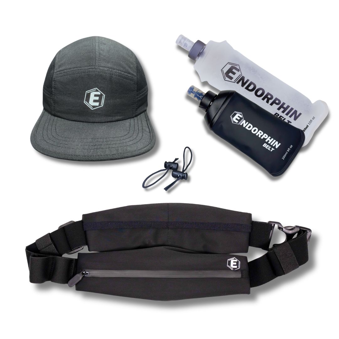 An Endorphin running belt, two soft water flasks, and a gray athletic cap on a white background.