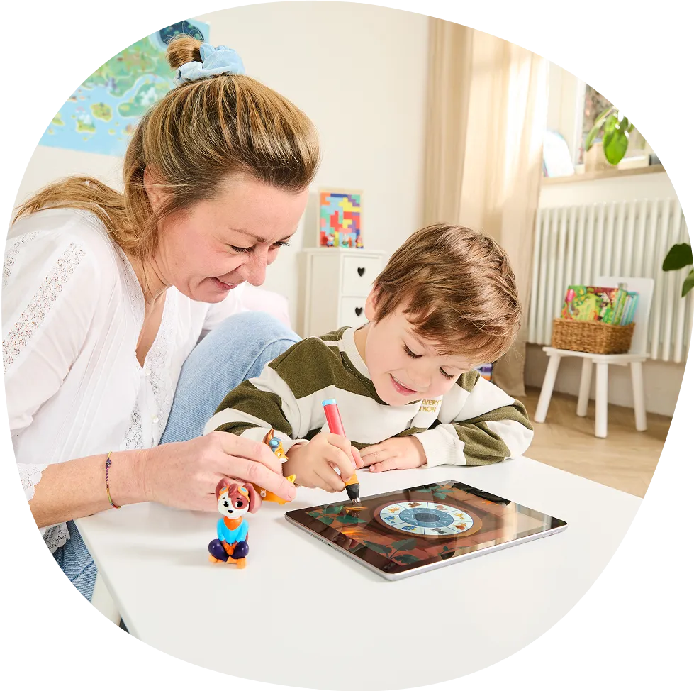 Woman and child drawing on a tablet together, smiling.