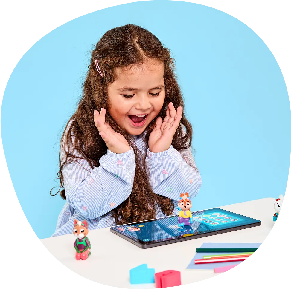Girl excitedly looking at a tablet with small animal figurines.