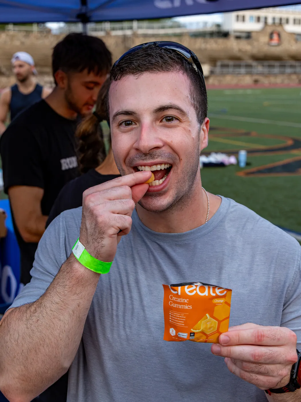 A runner at a Create run club eating a gummy from an Orange pack