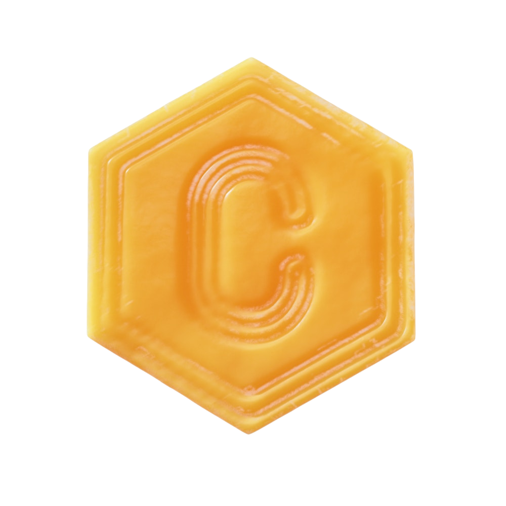 Yellow hexagonal object with a letter 'C' embossed on it.