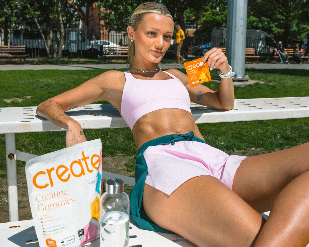 Athlete resting on the bleachers with the Variety pouch and an Orange pack