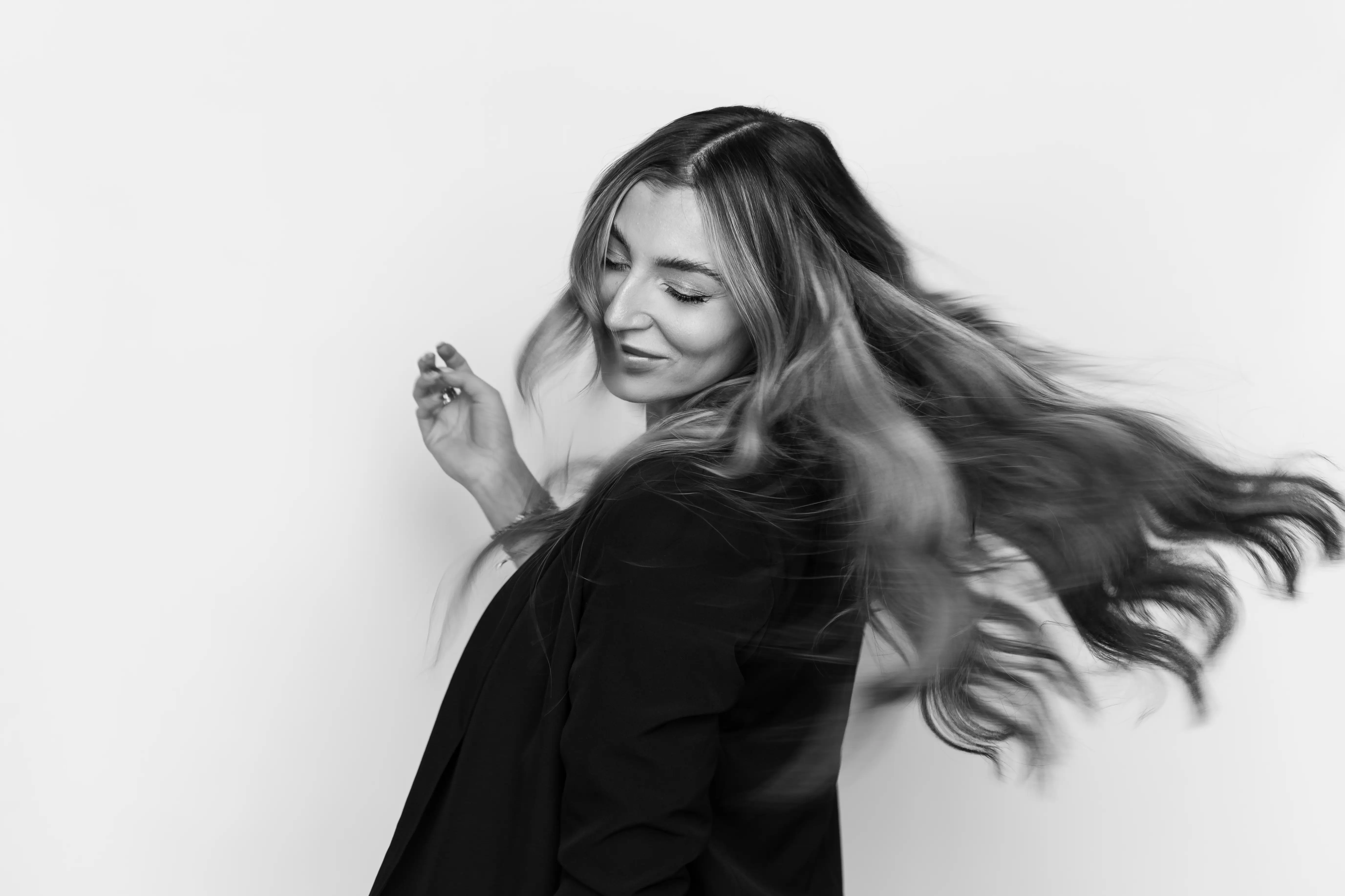 Black and white photo of a woman spinning with flowing hair.