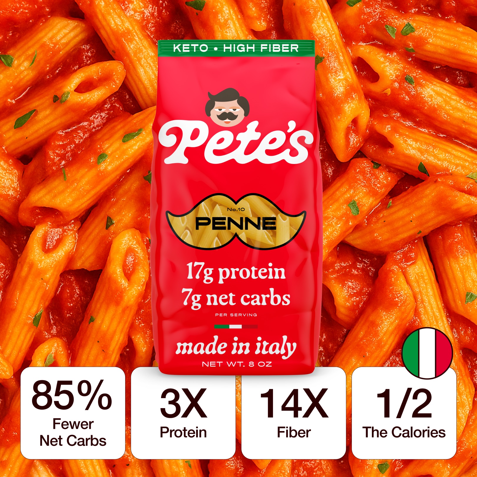 A bag of Pete's Keto Penne pasta shown over a close-up of cooked penne in red sauce.