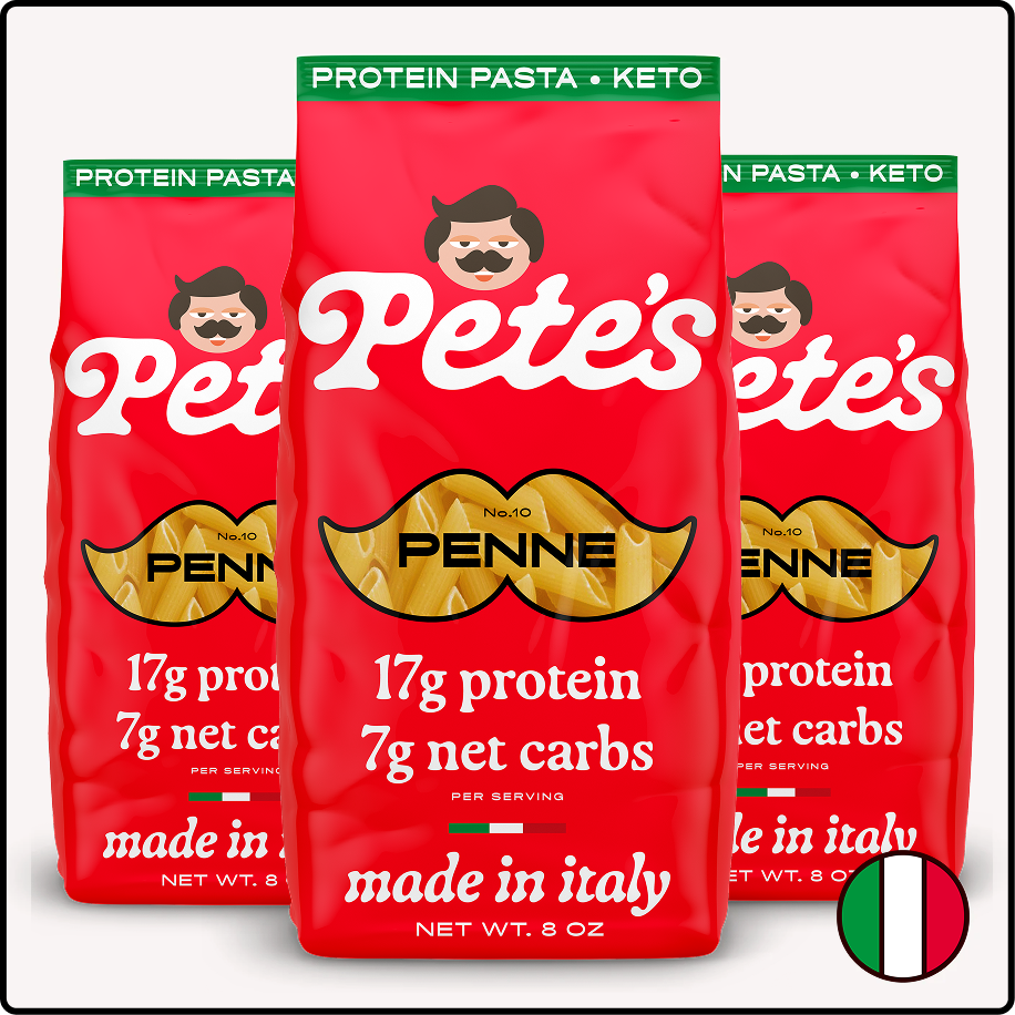 Three red bags of Pete's Keto Protein Penne Pasta, made in Italy, against a white background.