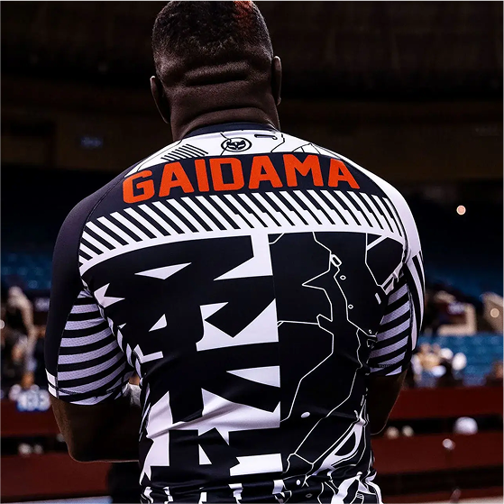 Person wearing a patterned shirt with 'GAIDAMA' on the back.