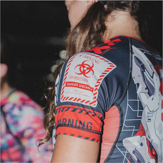 Person wearing a shirt with a biohazard warning design on the sleeve.
