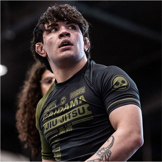 Person in a jiu-jitsu uniform with skull design, looking to the side.