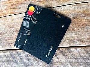 A black Rhinokey card and a Mastercard on a wooden surface.