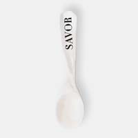 A spoon with the word 'SAVOR' on its handle, against a plain background.
