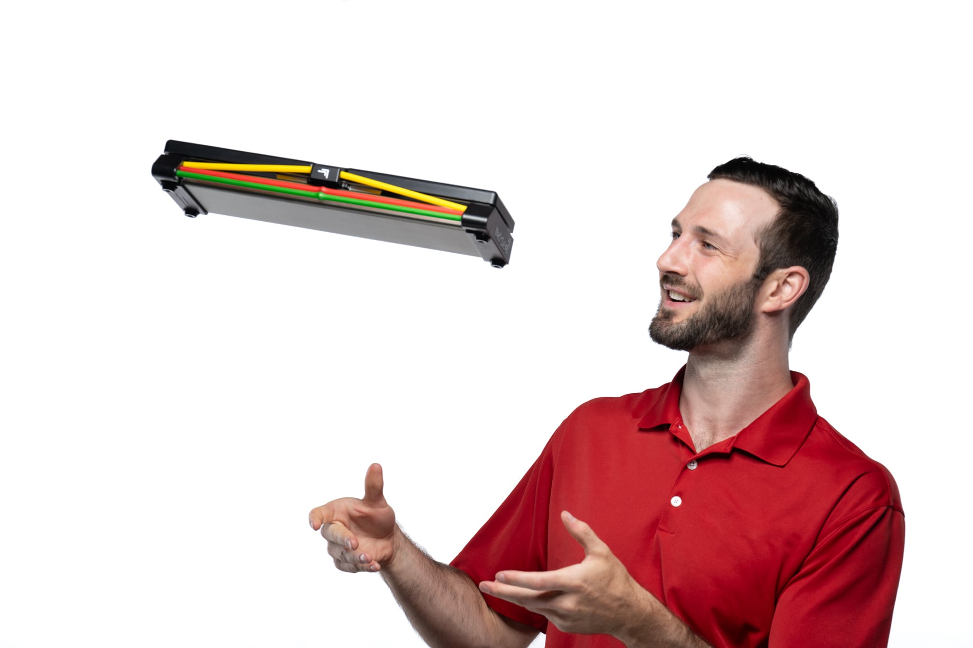 Man in red shirt tossing a colorful tool organizer.
