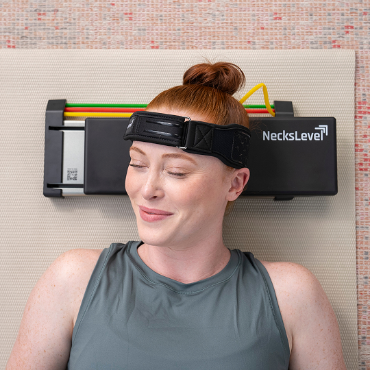 Person lying on a mat with a NecksLevel neck device.