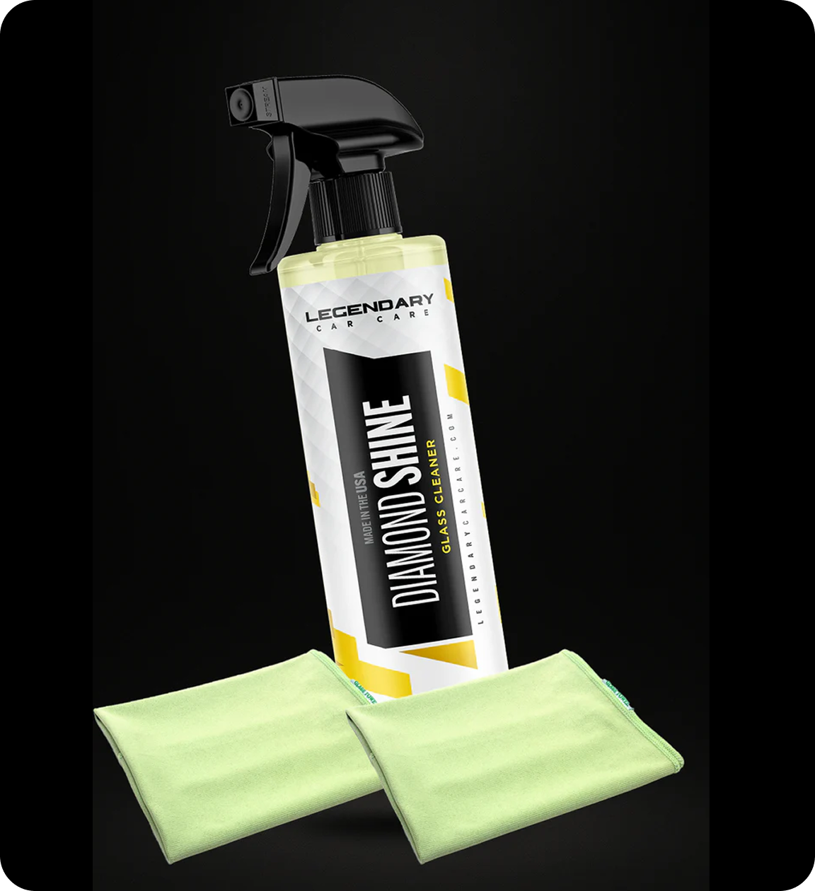 A spray bottle of Legendary Car Care Diamond Shine glass cleaner with two light green microfiber towels.