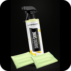 A spray bottle of Legendary Diamond Shine Glass Cleaner with two light green microfiber cloths.