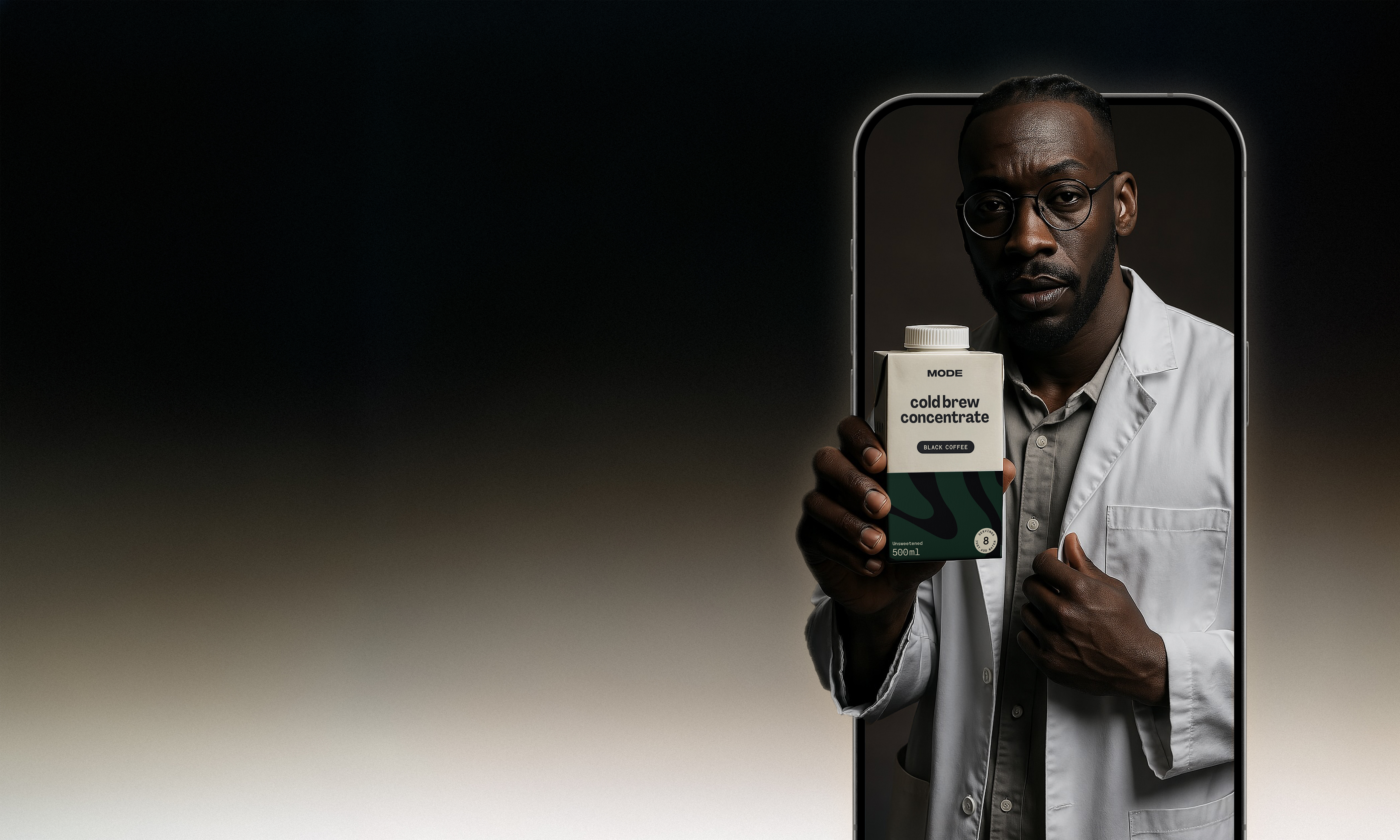 Person holding a carton of cold brew concentrate inside a phone frame.