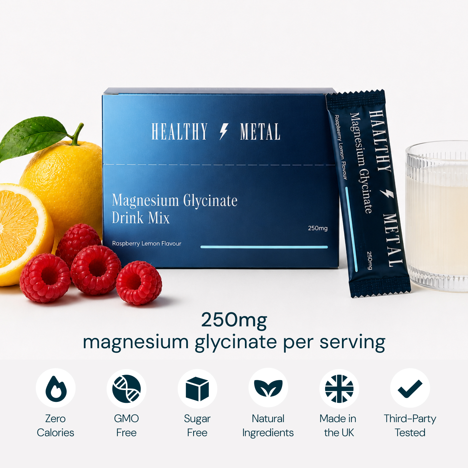A box and sachet of Healthy Metal drink mix with lemons, raspberries, and a glass of the drink.