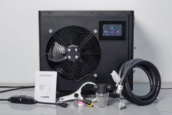 Black cooling unit with fan, display, hose, and accessories on a table.