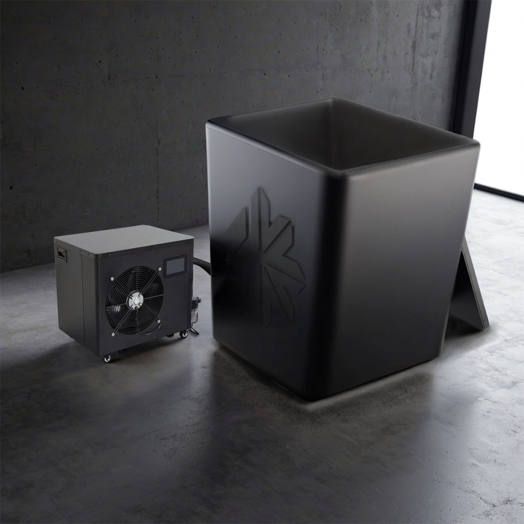 Black cube and cooling unit on a concrete floor.