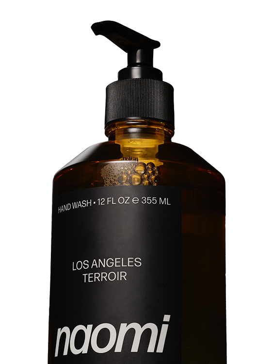 Amber bottle with black pump labeled 'naomi' hand wash.