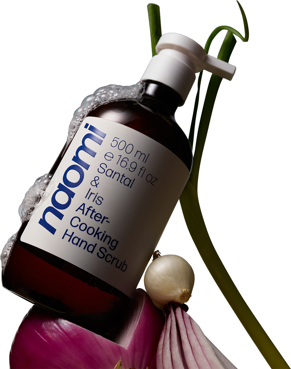 Bottle of hand scrub with seashells and a lobster claw.