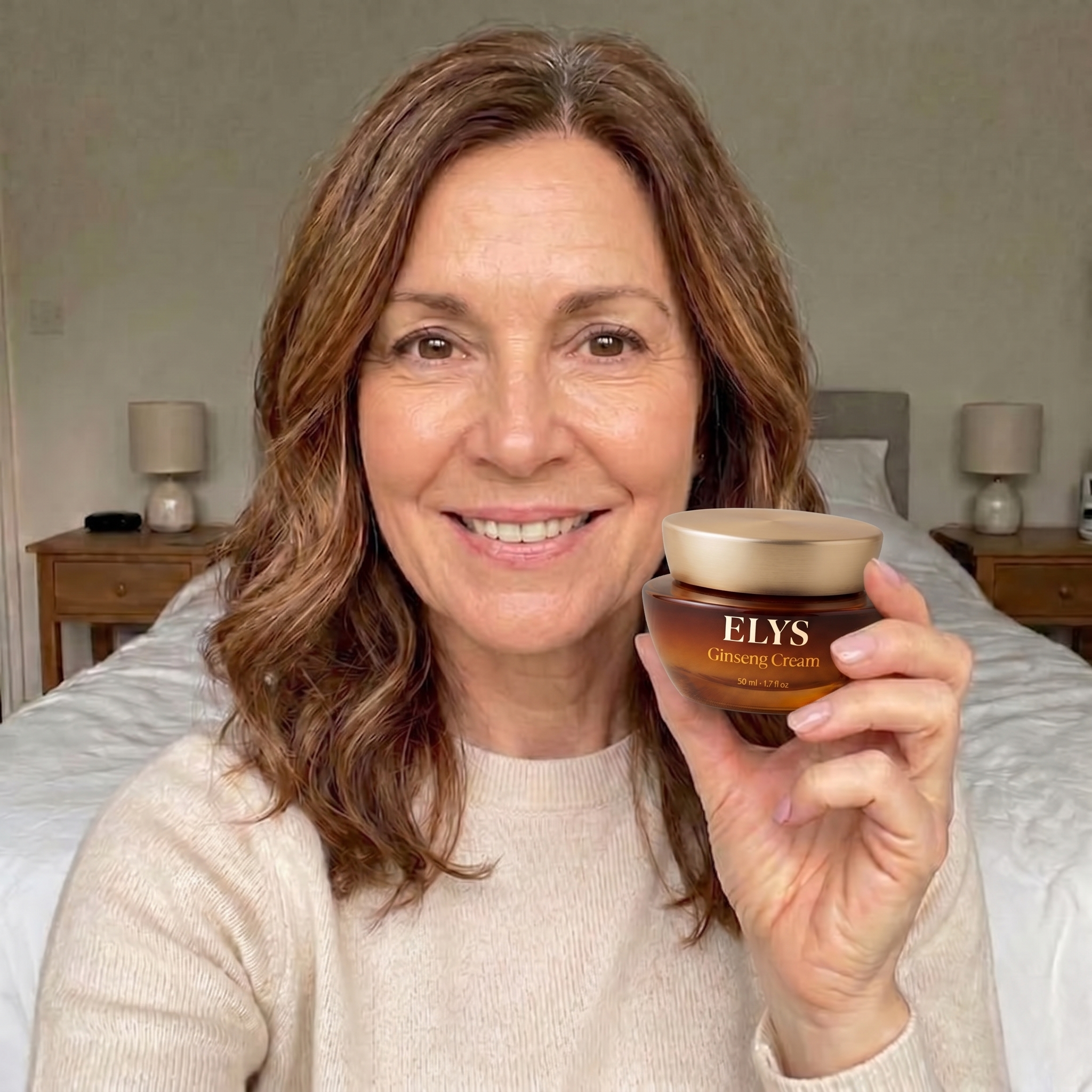 A smiling woman in a bedroom holds up a jar of ELYS Ginseng Cream.