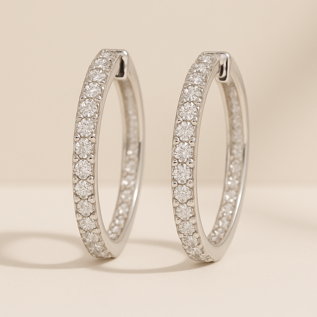A pair of diamond-studded hoop earrings on a neutral background.