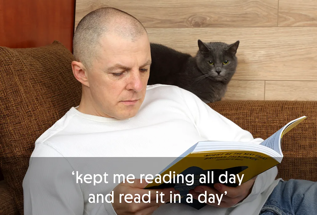 Man reading Thunderpaws on a couch, with a grey cat looking on, with the quote “kept me reading all day and read it in a day.”