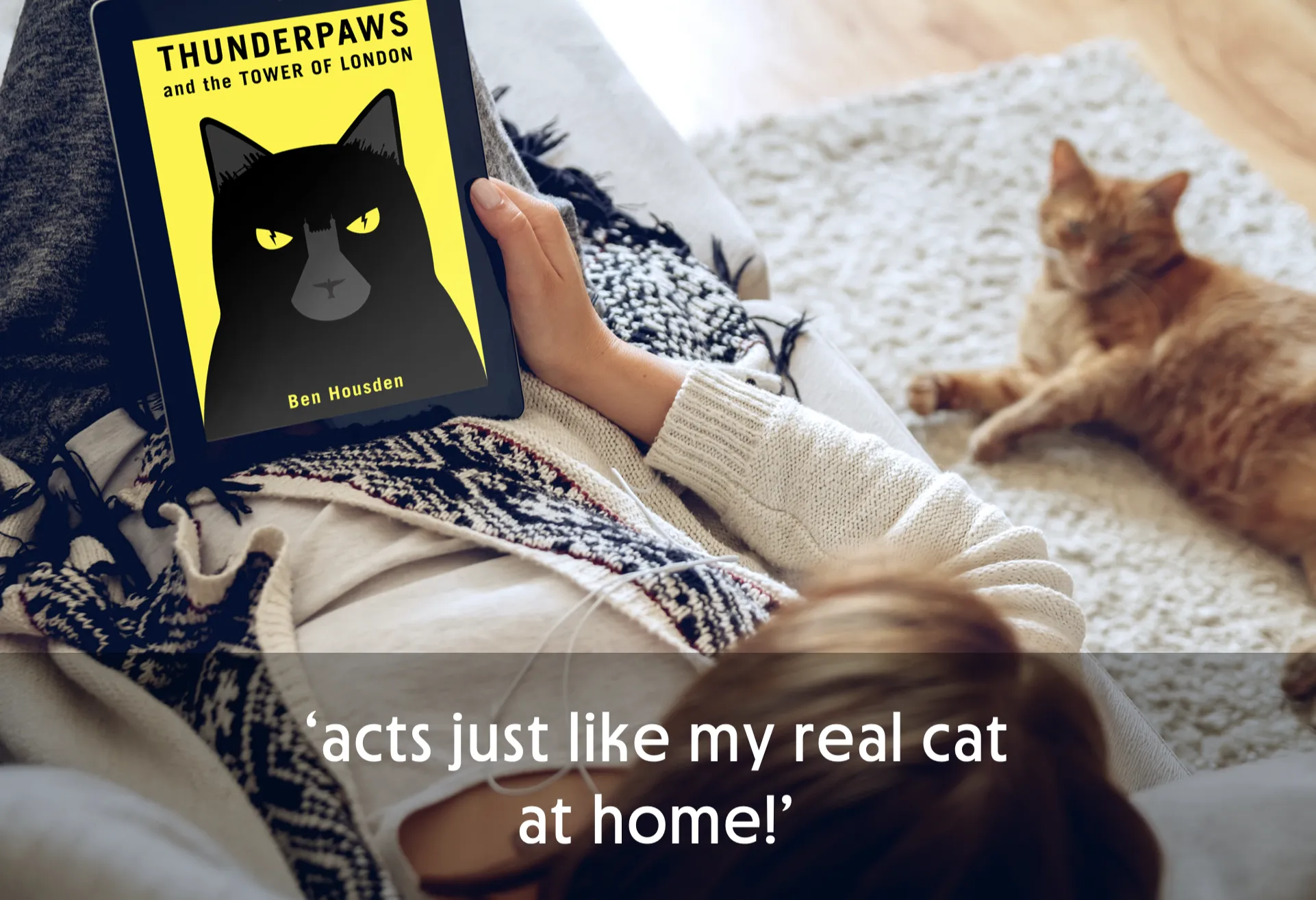 Person reading a tablet with a cat book cover, cat lying nearby.