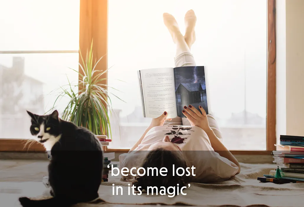 A woman lying on her back reading Thunderpaws with her feet up against a window, while a black and white cat looks away, with the quote “become lost in its magic.”