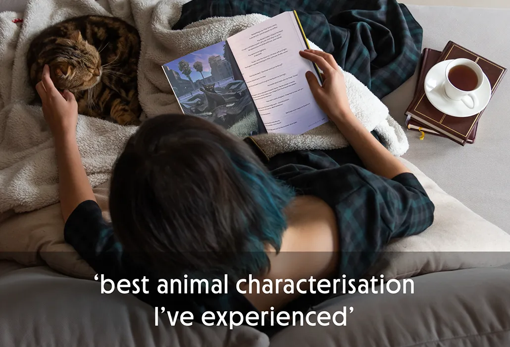 Woman reading Thunderpaws with a cat and a cup of tea nearby, with the quote “best animal characterisation I’ve experienced.”