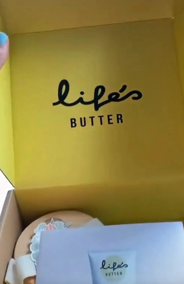 Open yellow box with 'life's butter' text and products inside.