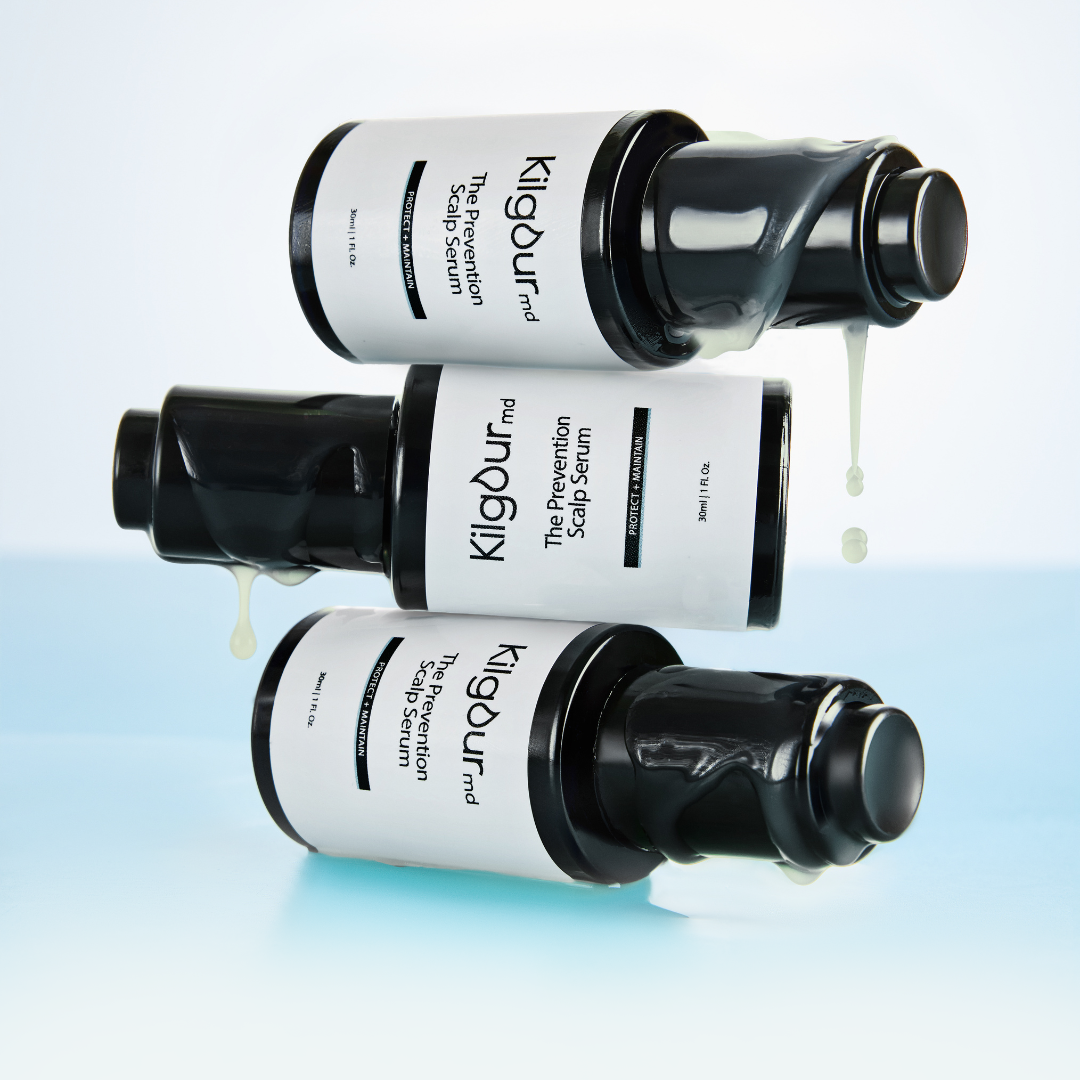 Three bottles of scalp serum with liquid dripping from them.